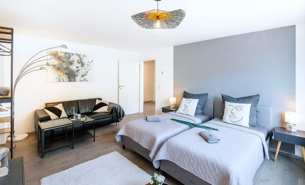 Monteurunterkunft WU03 in Wuppertal: Schlafzimmer mit 2 Betten und einem Sofa.